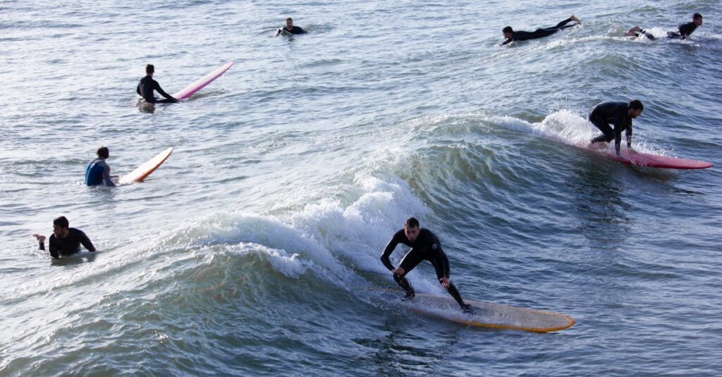 Surfers enjoying ocean waves on a sunny day, capturing the thrill of water sports.