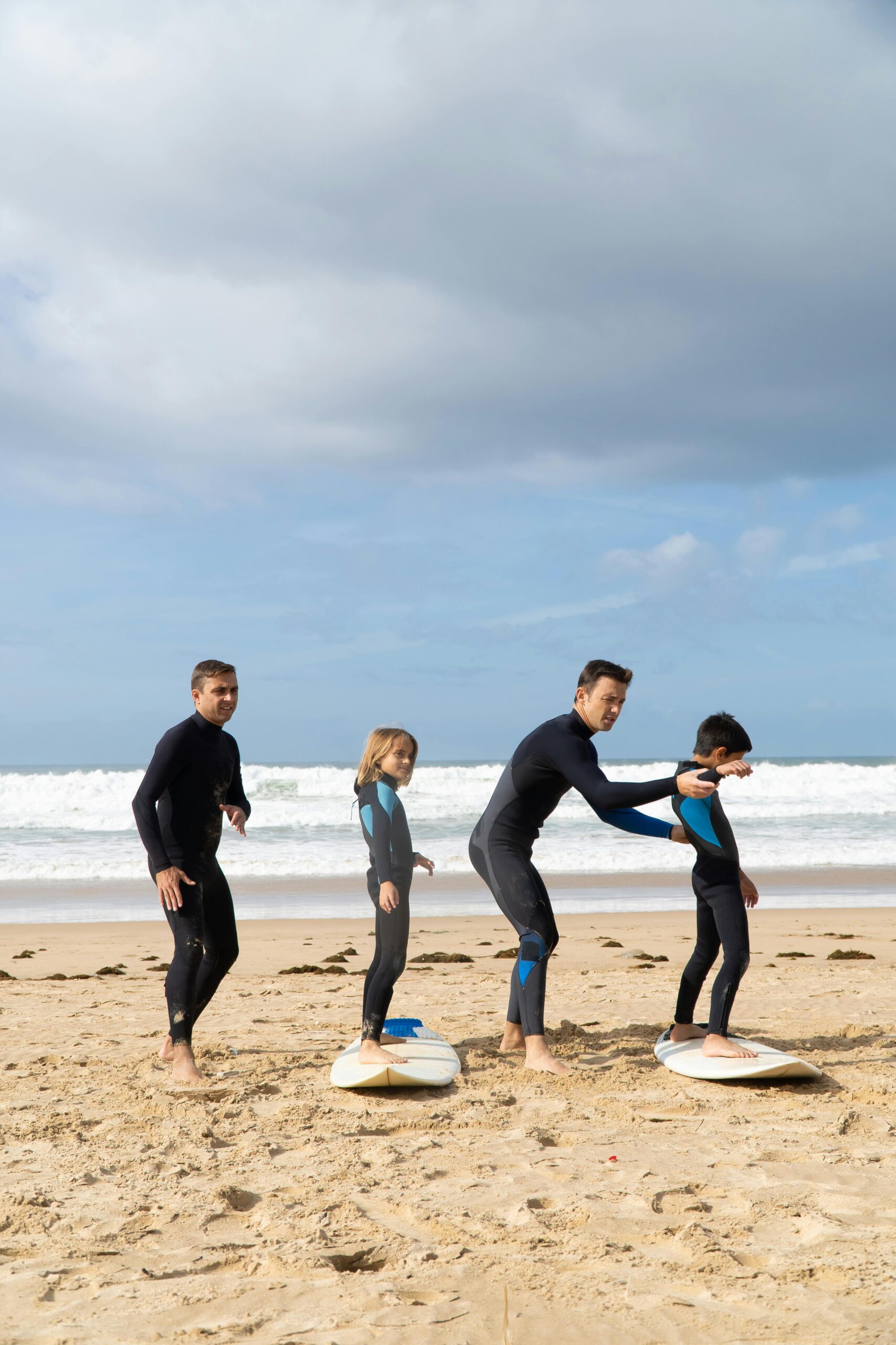 Surfing instructor teaches kids on a beach in Portugal.